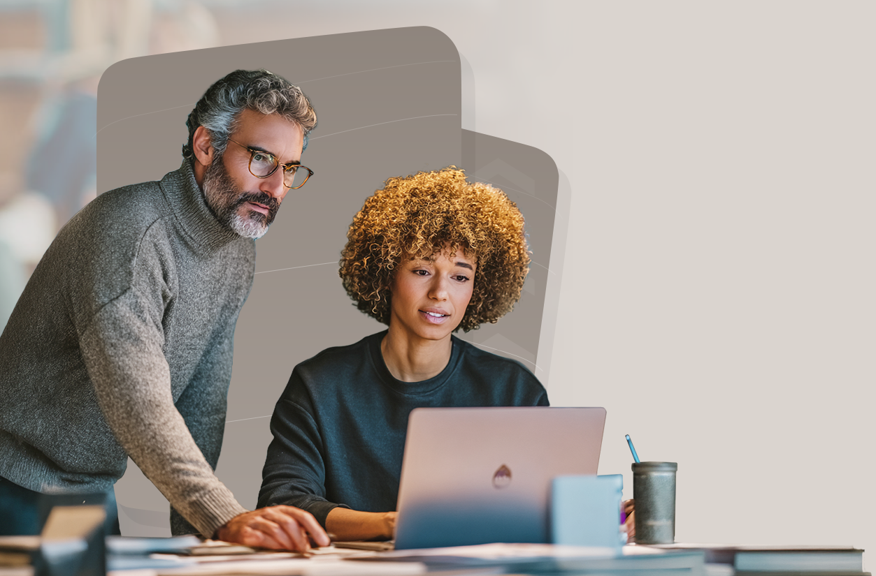 An IMS expert and a learning professional collaborating at a laptop